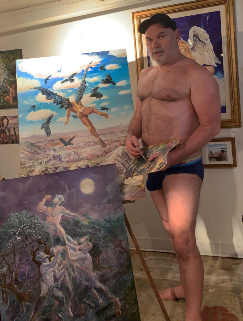 Photo of artist Marc DeBauch standing in his studio.